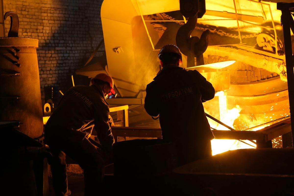 Workers managing molten metal at a steel plant, representing Bokaro's SAIL Steel City economy