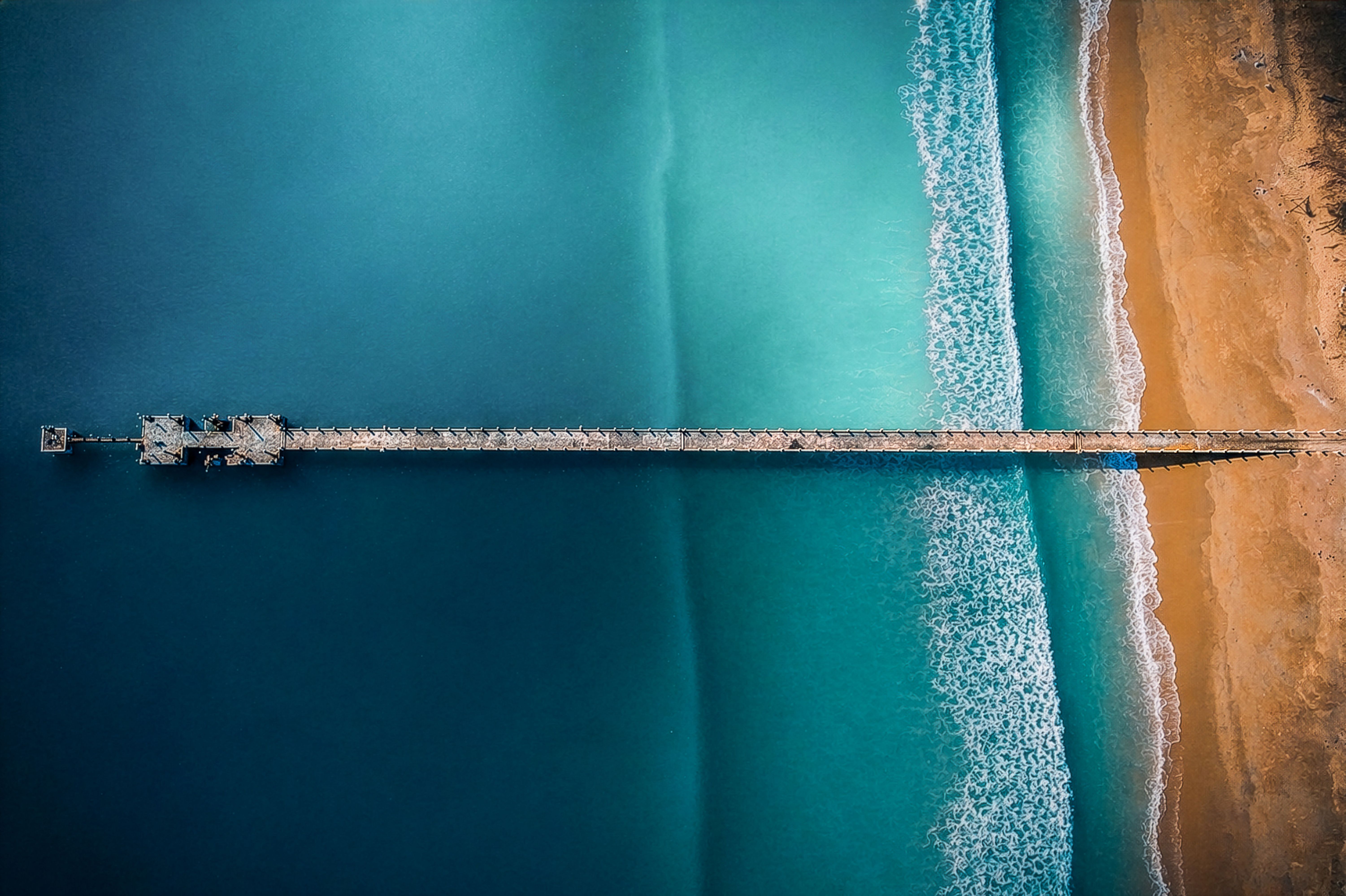 Aerial View of Pier Extending into Ocean · Free Stock Photo