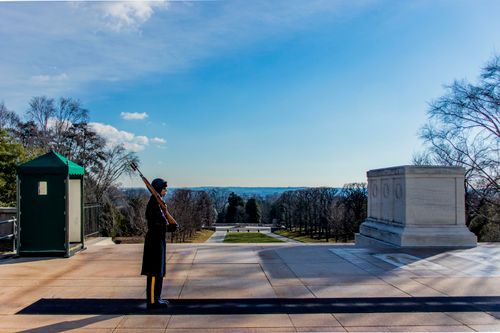 Free Guard at the Tomb of the Unknown Soldier in Arlington, Washington D.C., USA under a clear blue sky. Stock Photo