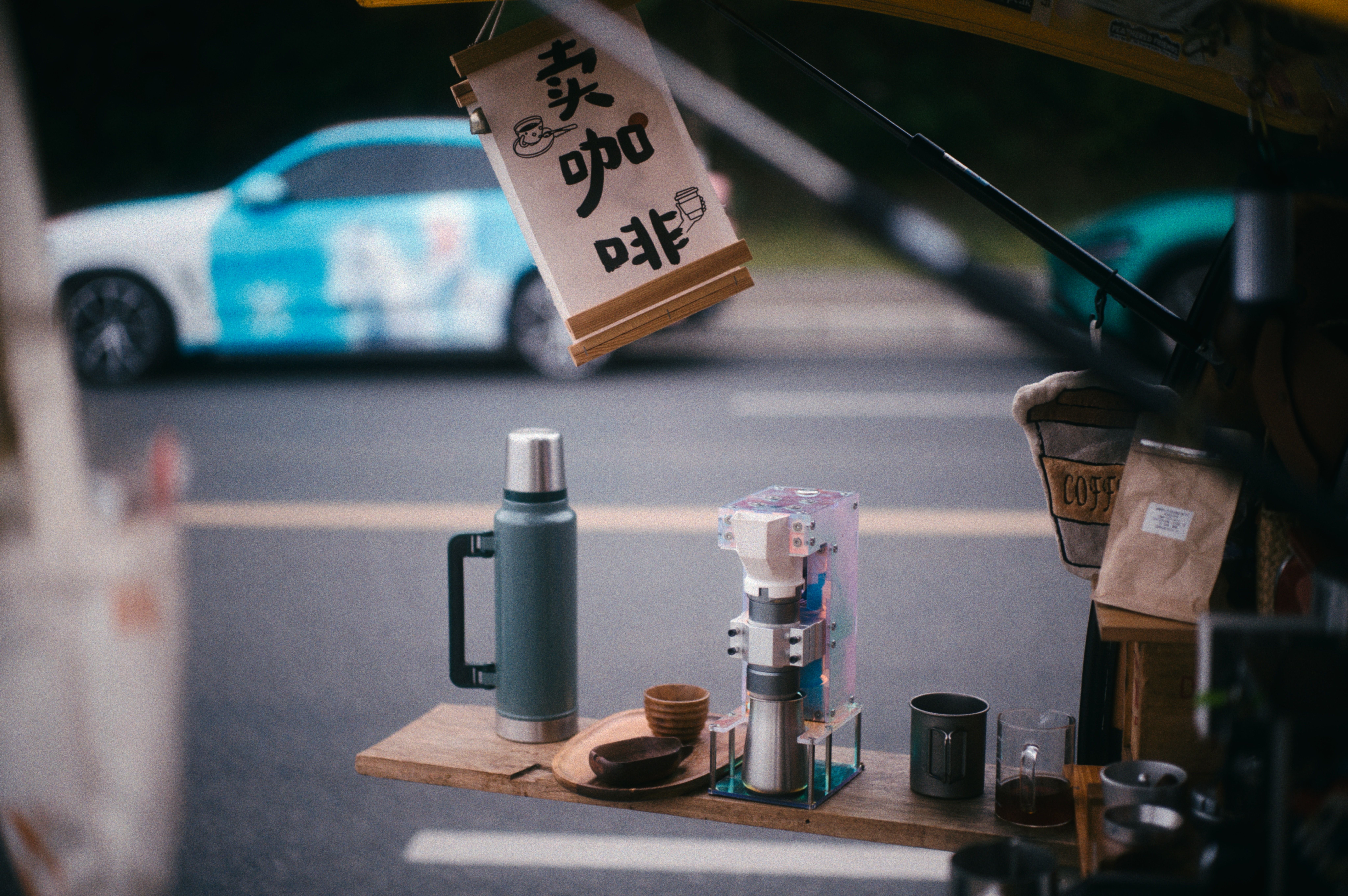 a quiet morning scene in an Asian city, perhaps a small street with a coffee cup visible