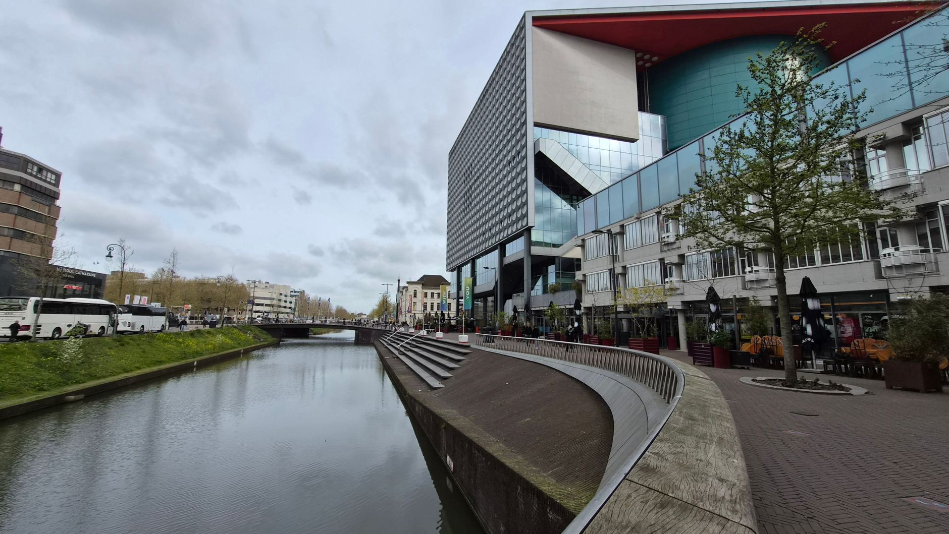 Contemporary architecture along a canal in Utrecht, showcasing modern design elements and reflections.
