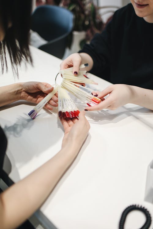 Client carefully selecting her nail color