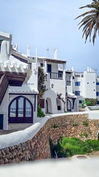 Whitewashed Mediterranean architecture in Binibeca, Menorca, captured on a sunny day.