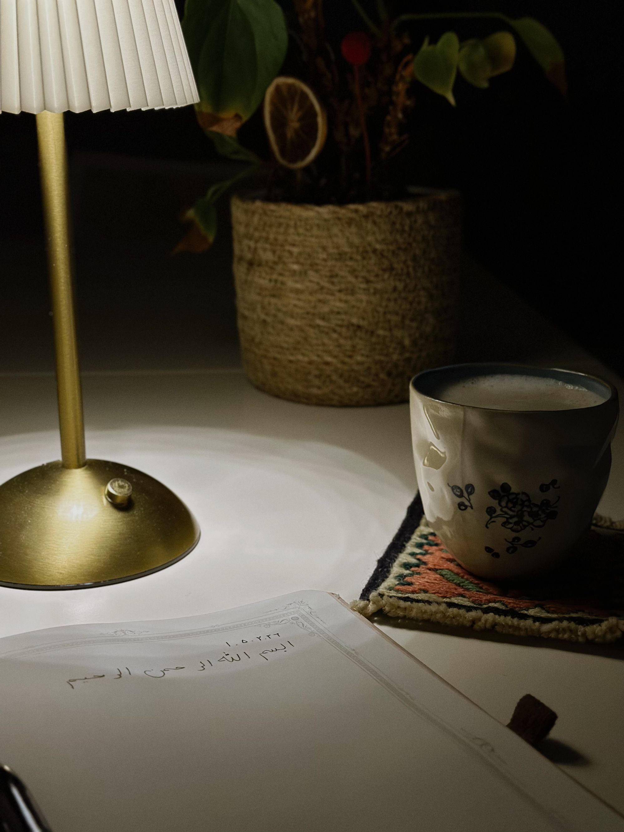 A cozy nighttime desk scene lit by a single lamp, evoking the late-night overwhelm Function is designed for