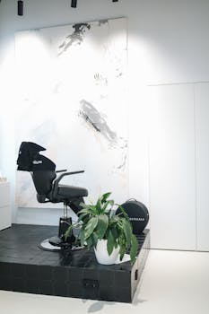 Sleek black salon chair in a minimalist beauty salon setting with abstract art.