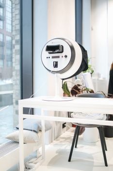 A modern skincare device in a bright beauty salon with contemporary decor.