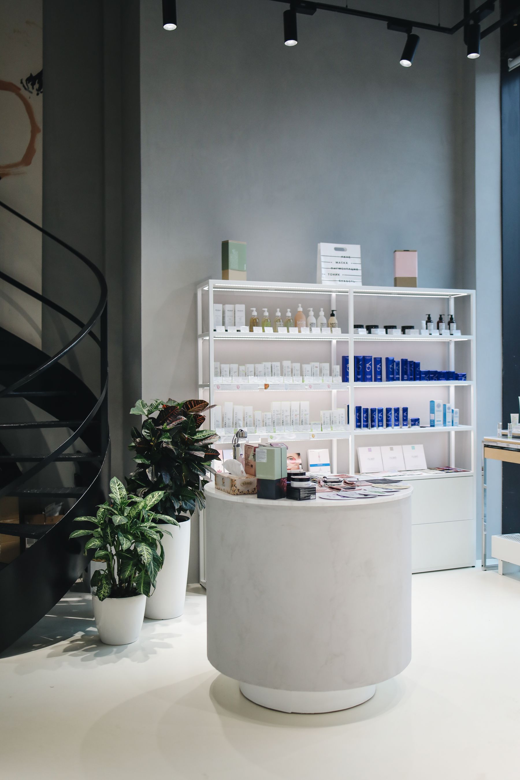 Elegant beauty studio interior with skincare products displayed on warm shelves