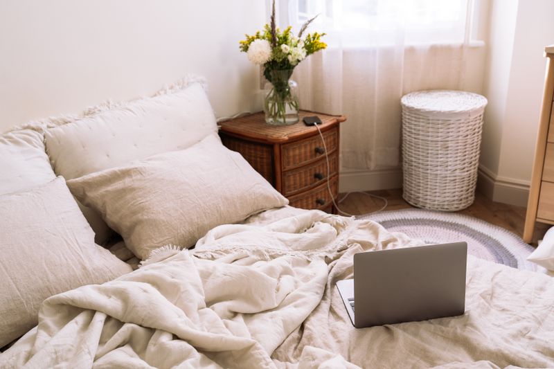 Linen-covered bed in morning light by Tina Simakova on Pexels