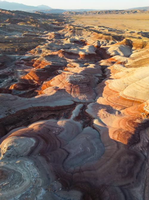 Free A breathtaking aerial view of Utah's colorful rock formations resembling a painted desert landscape. Stock Photo
