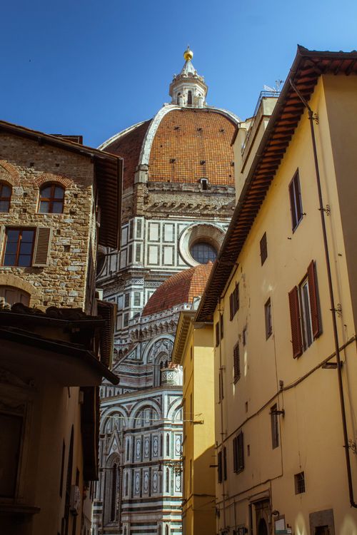 Free A stunning view of the Florence Cathedral and its domes framed by historic buildings in Florence, Italy. Stock Photo