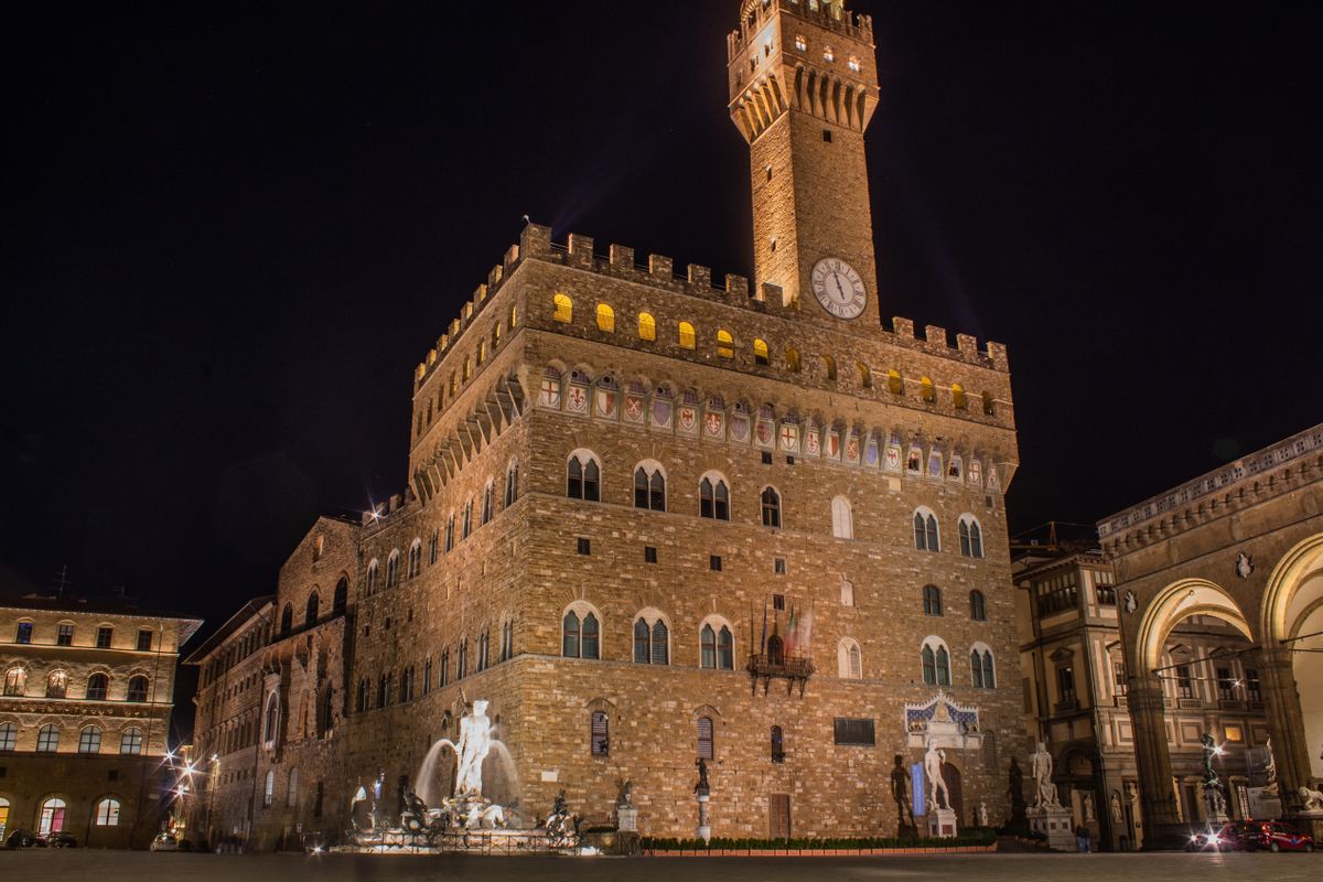 Piazza della Signoria Florence with Palazzo Vecchio tower David sculpture and Loggia dei Lanzi at sunset