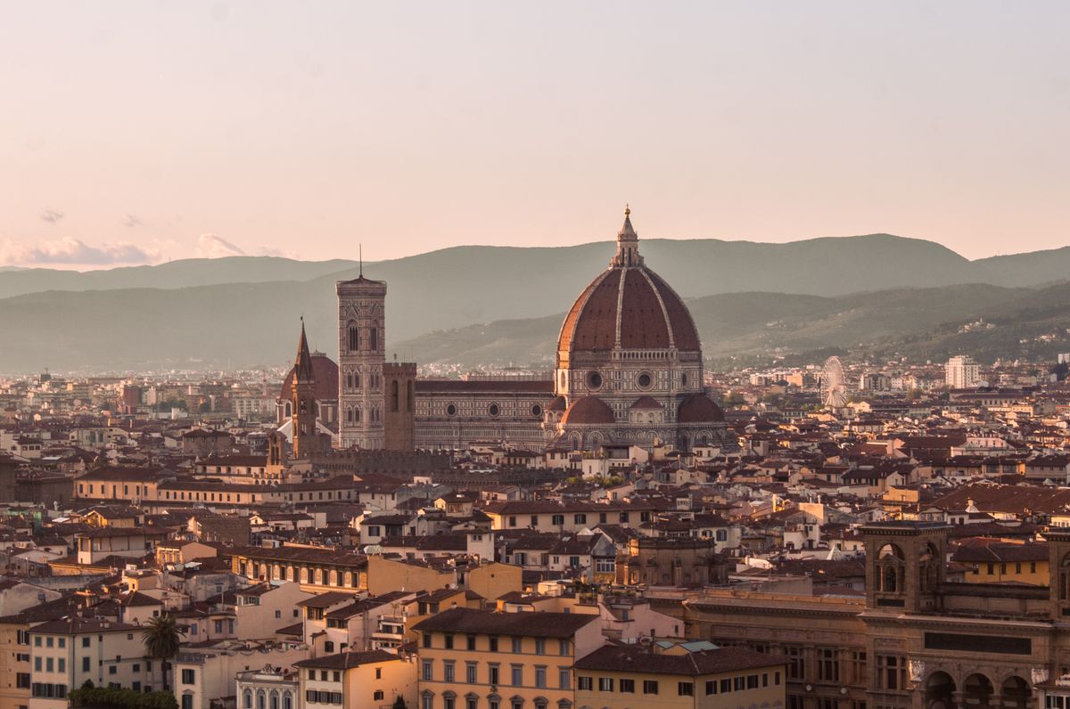 Sunset over Florence Italy with Duomo dome golden light Tuscan hills view from Piazzale Michelangelo