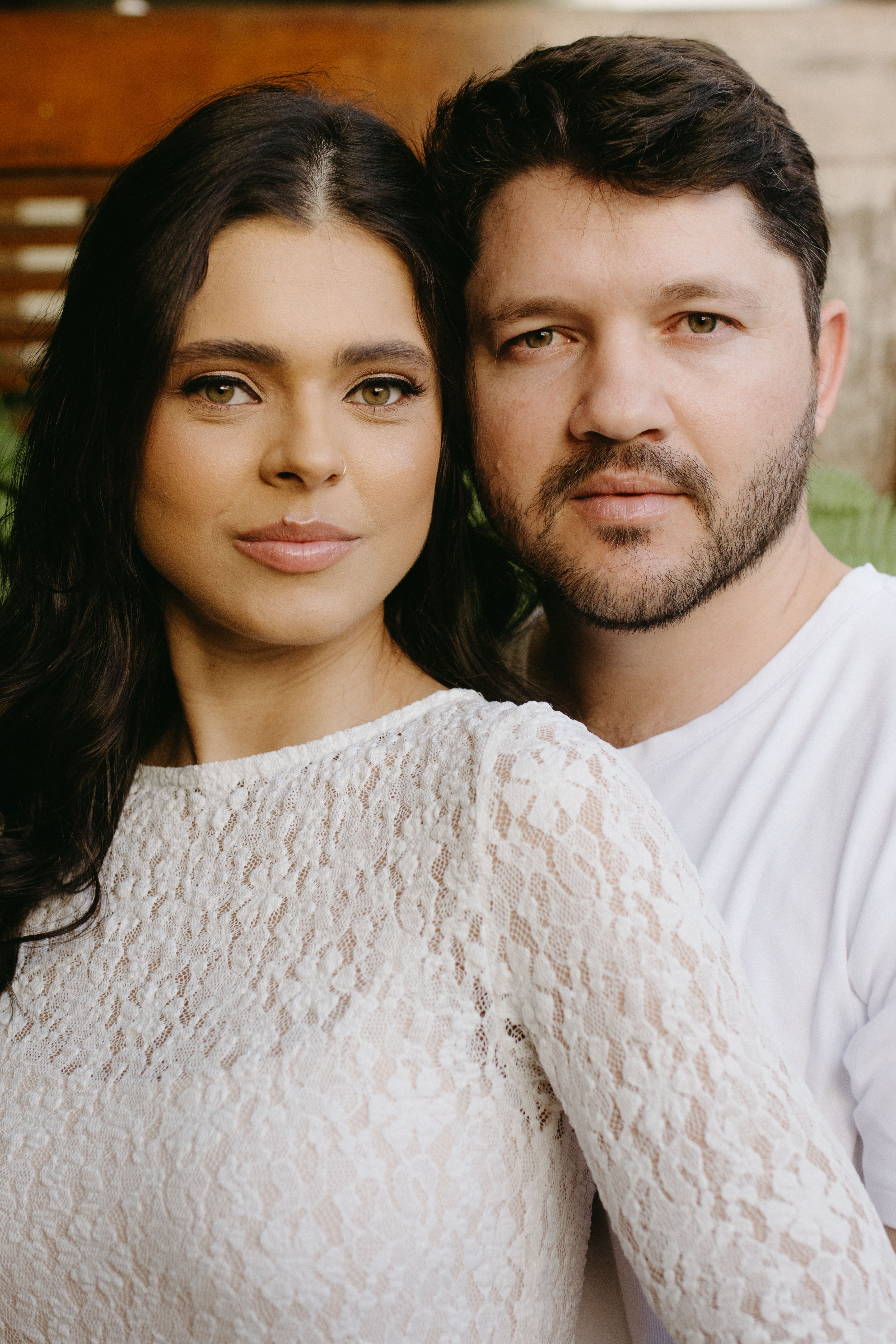 Romantic engagement photo capturing a loving couple in a serene outdoor backdrop.