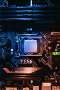 Detailed view of a computer motherboard featuring a central processor and RAM slots, highlighting its intricate design.