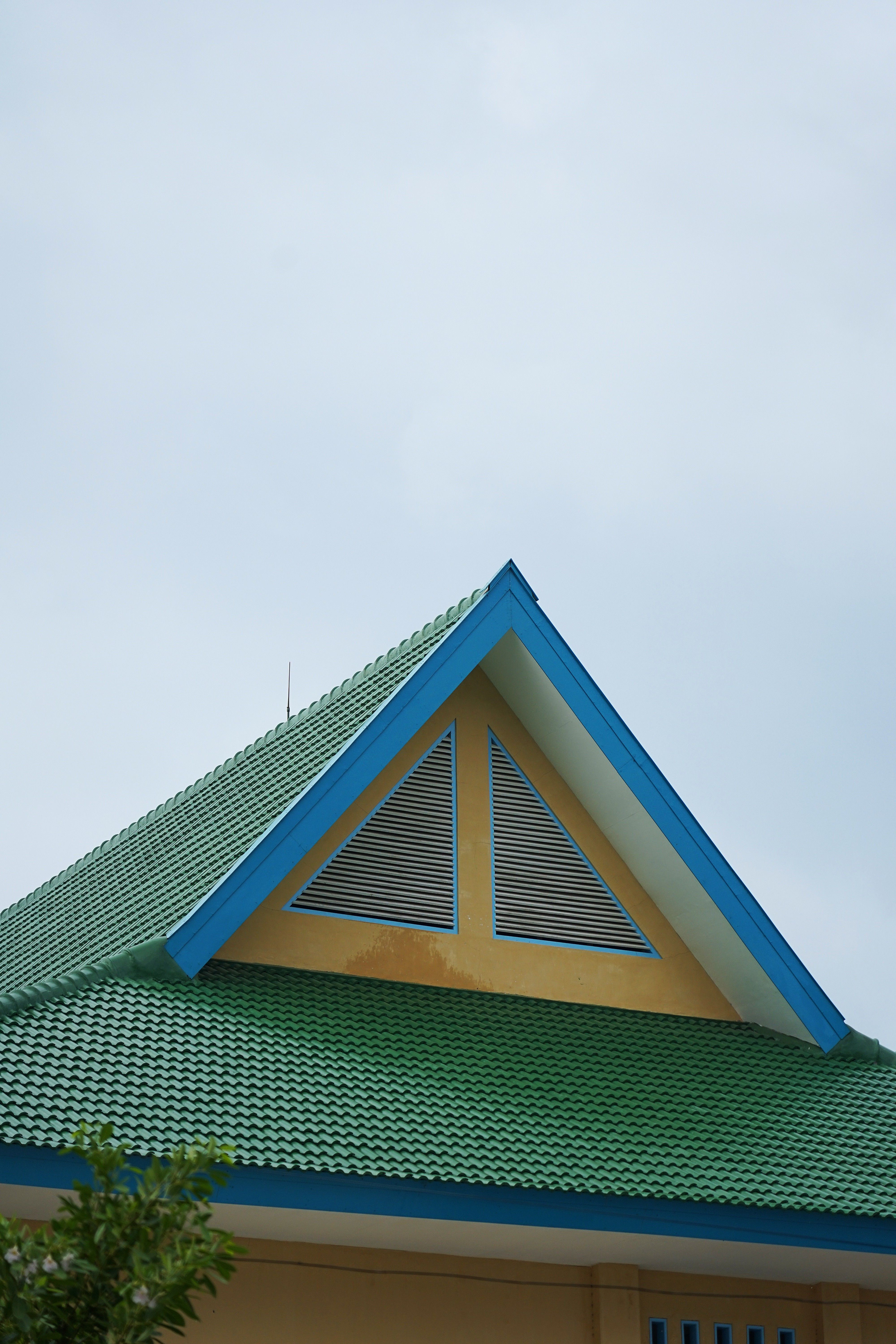 A minimalist green and blue roof design in Situbondo, Indonesia.