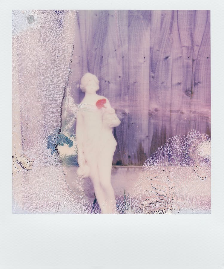 Polaroid Photo Of A Statue