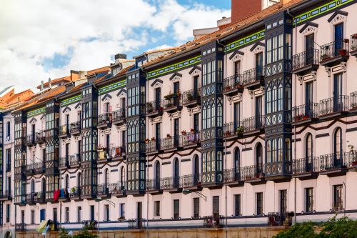 Free Charming European apartment facade featuring unique patterns and vibrant colors under a bright sky. Stock Photo