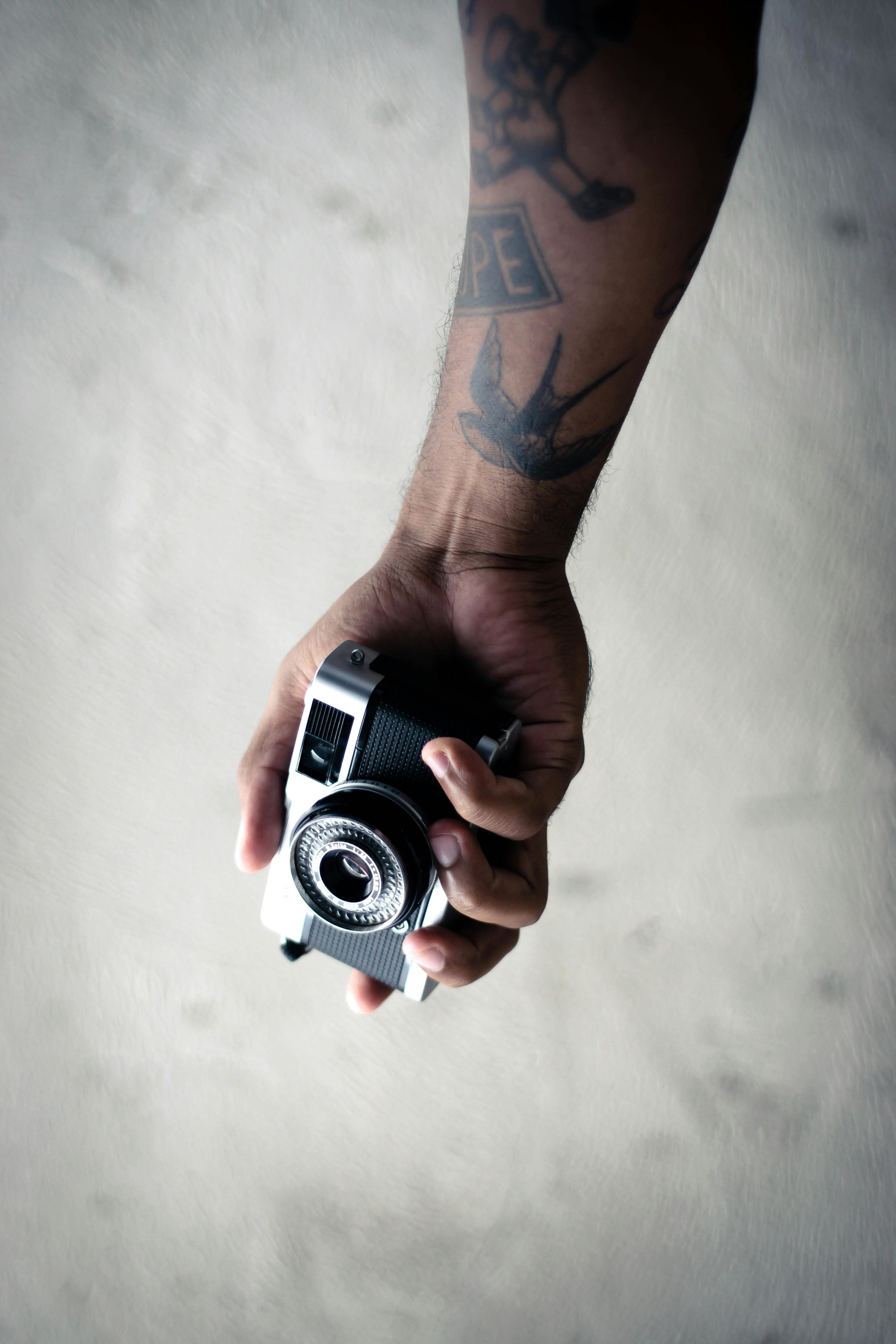 Smile with a camera tattoo for an upcoming talented photographer done at  Xpose Tattoos Jaipur.