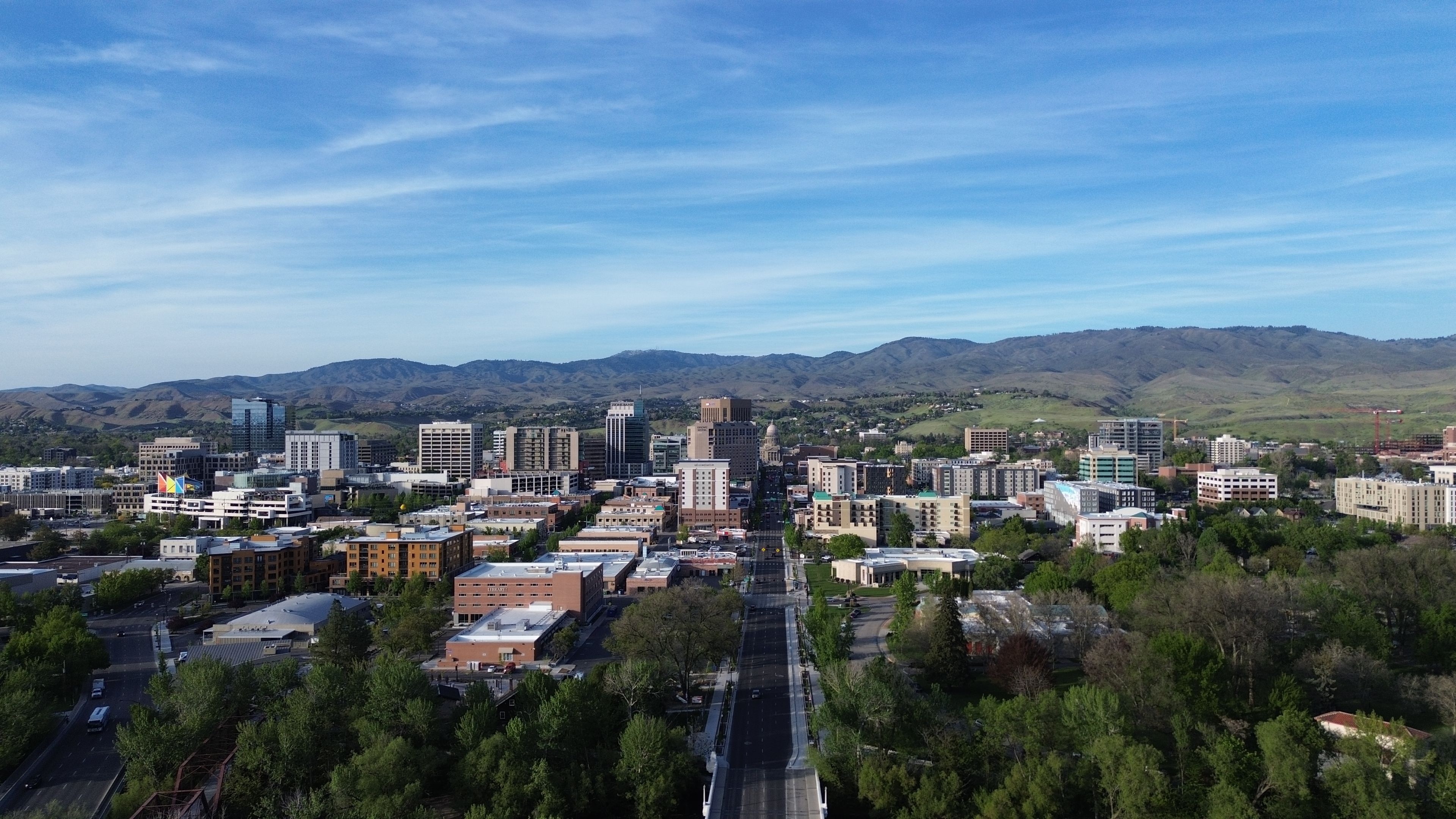 Idaho: Boise skyline with trees and foothills under a blue sky