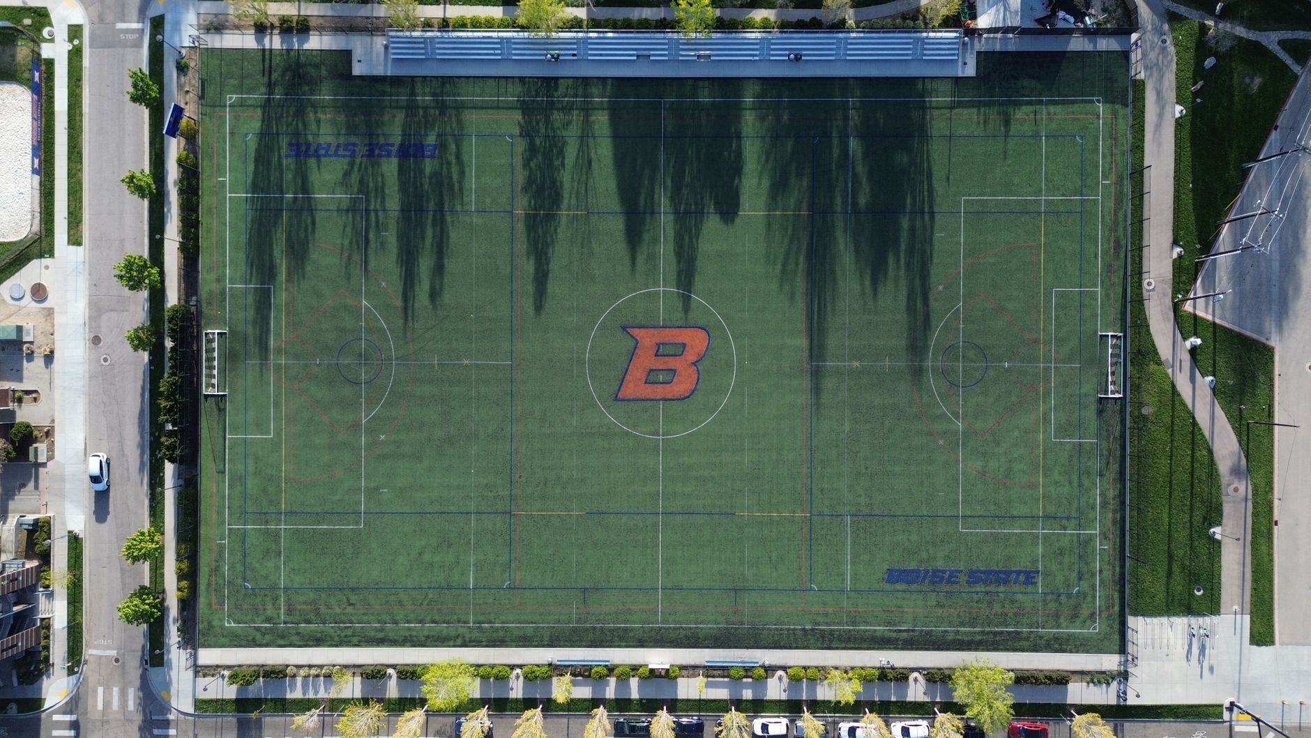 Drone shot of a football field at Boise State University, showcasing the artificial turf and surroundings.