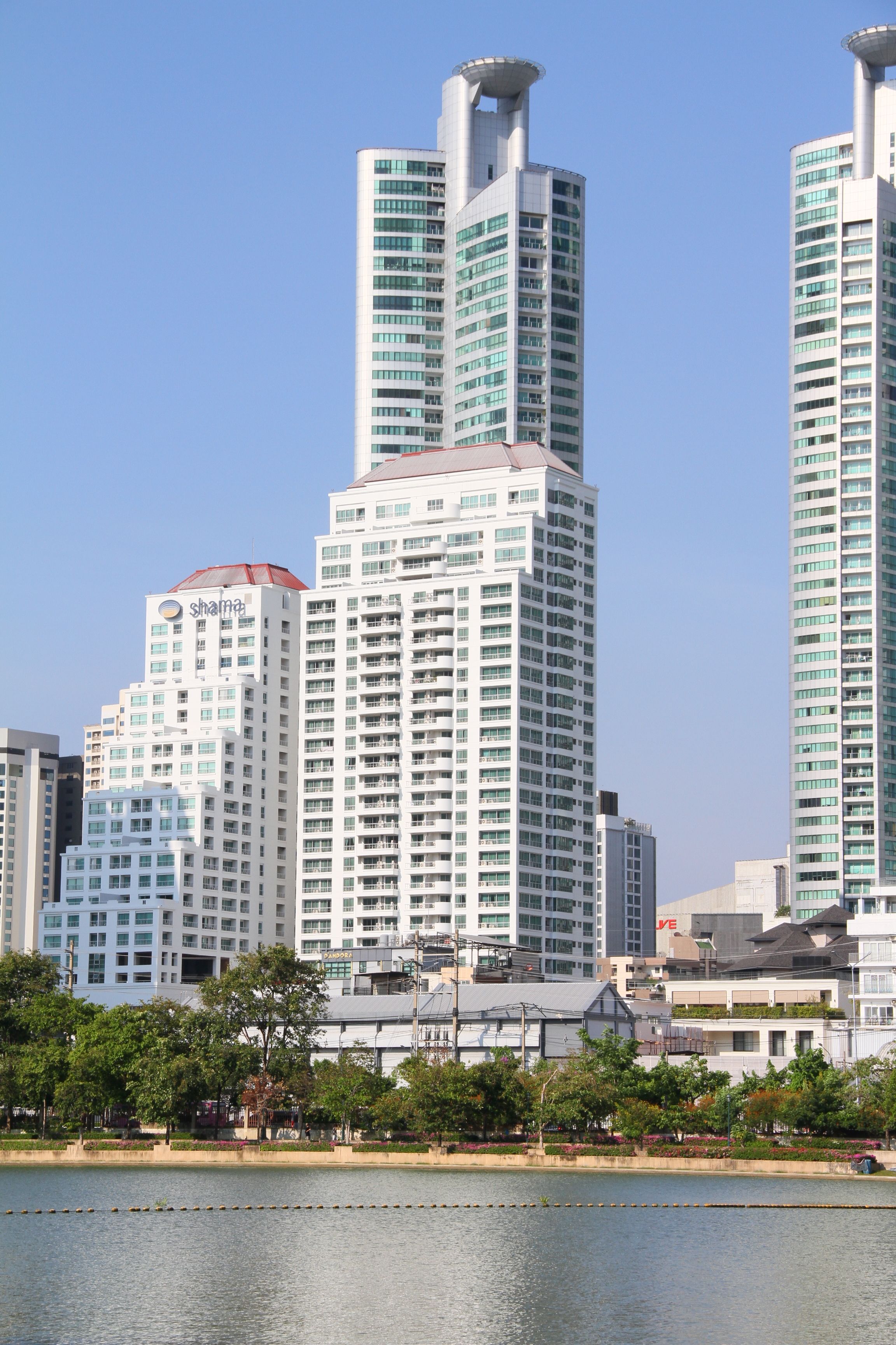 Modern High-Rise Buildings by Riverside in Cityscape · Free Stock Photo