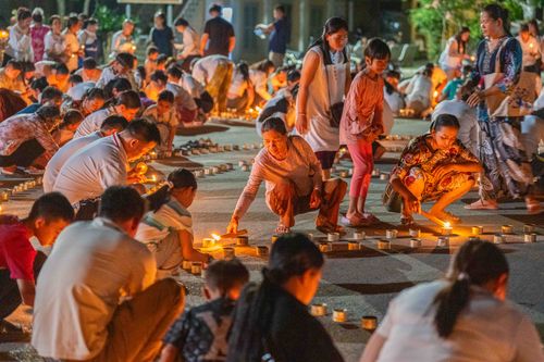 Free A community gathering during a night candlelight ceremony in Battambang province, Cambodia. Stock Photo