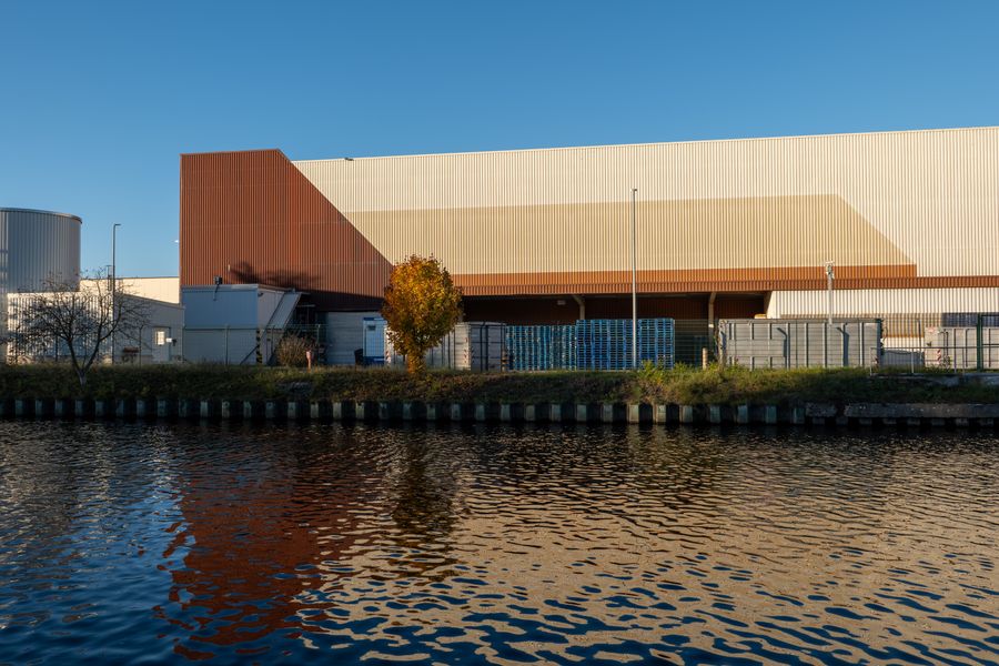 Modern facility reflected in calm water