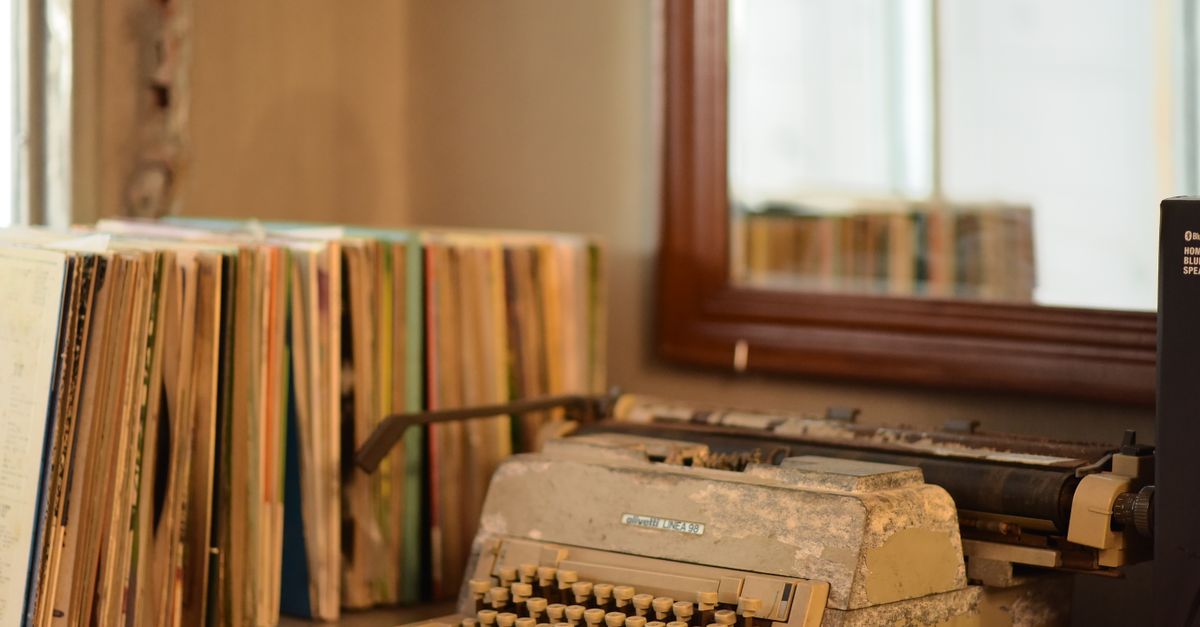 A cozy, brightly lit detective office with a typewriter and a stack of old books