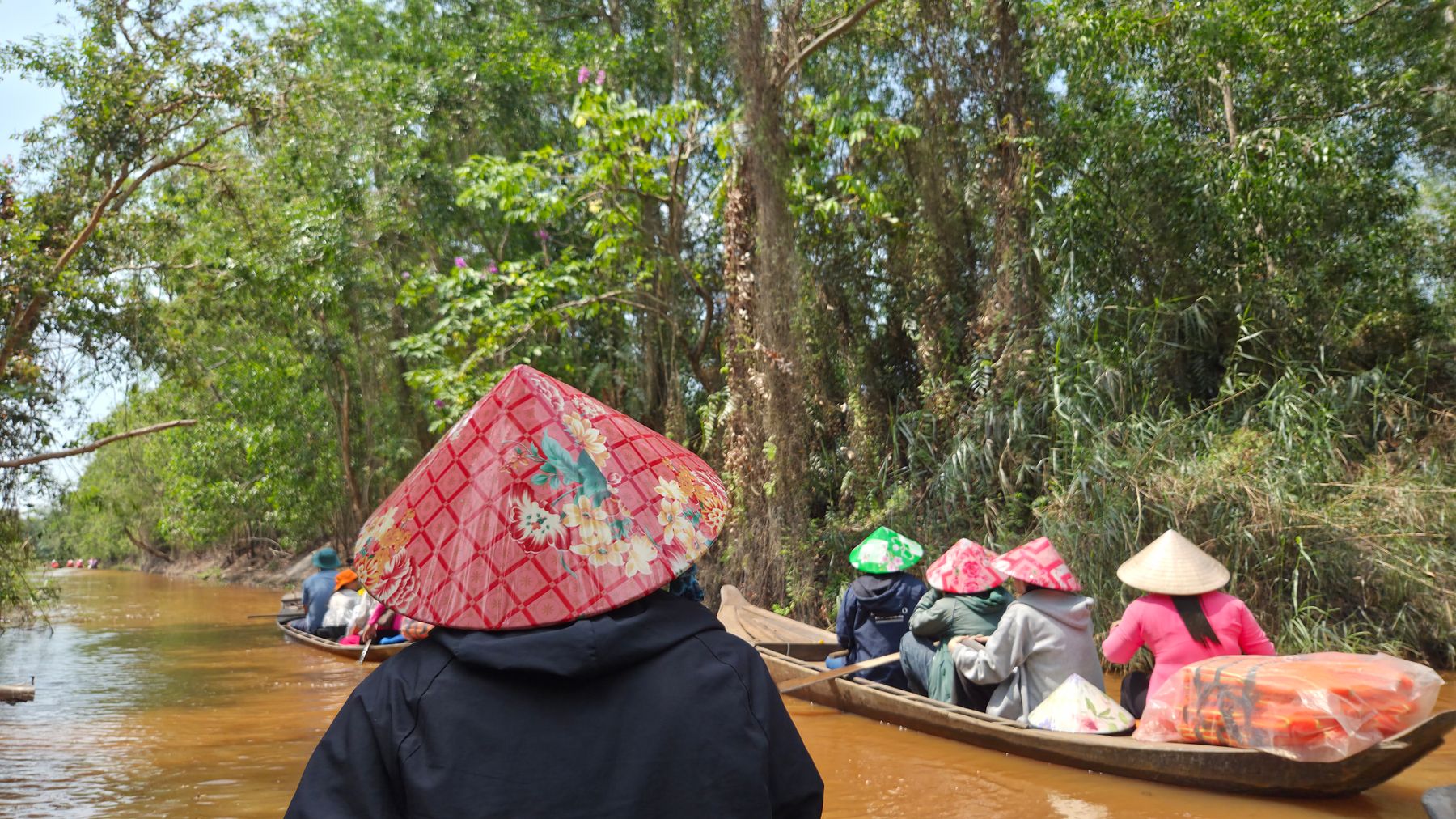 Scenic view of people on traditional boats in Phong Mỹ, Vietnam.