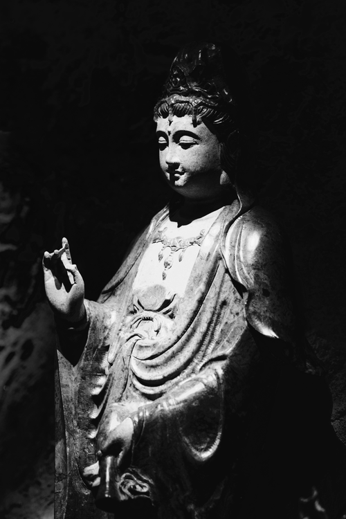 Free Monochrome photo of a serene Buddha statue in meditative pose, exuding calmness. Stock Photo