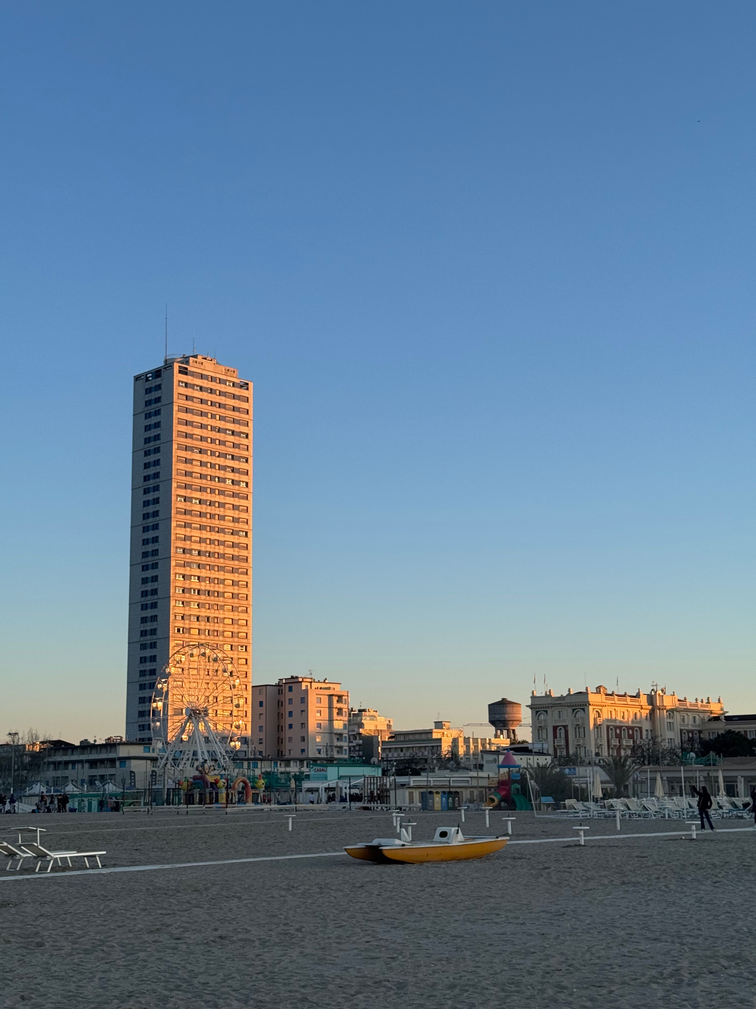 Sunset View of Rimini Beach and Tall Skyscraper · Free Stock Photo