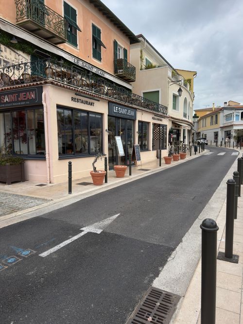 Free Street view of Le Saint Jean restaurant on a quaint European street with charming architecture. Stock Photo