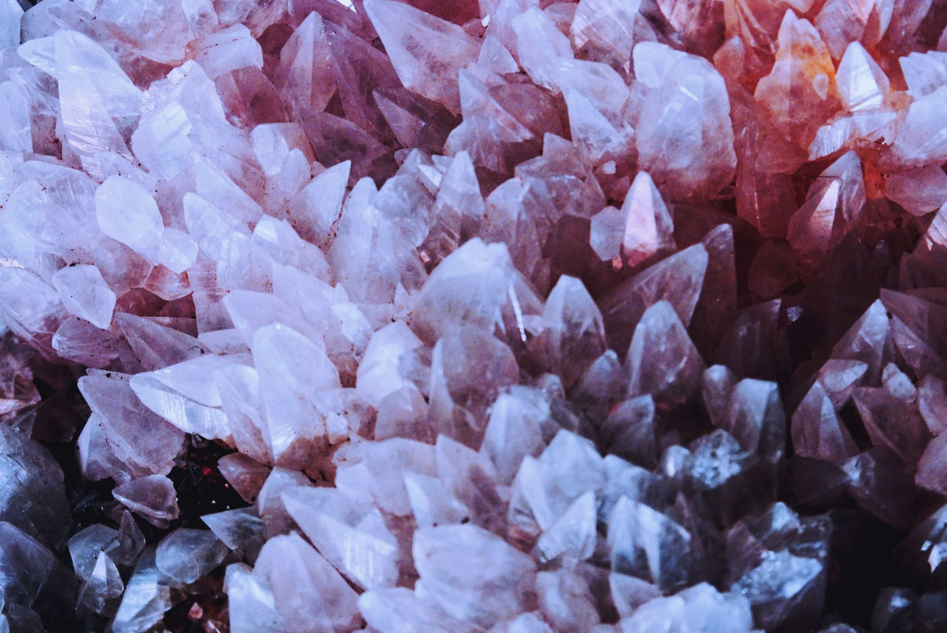 A stunning close-up of naturally occurring pink quartz crystals with sharp details.