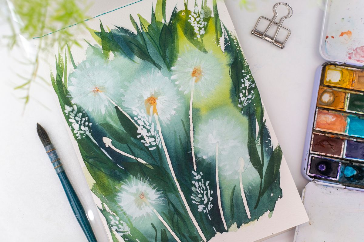 Watercolour dandelion study beside a well-used paint tin and brush — photo by Anna Krupa on Pexels