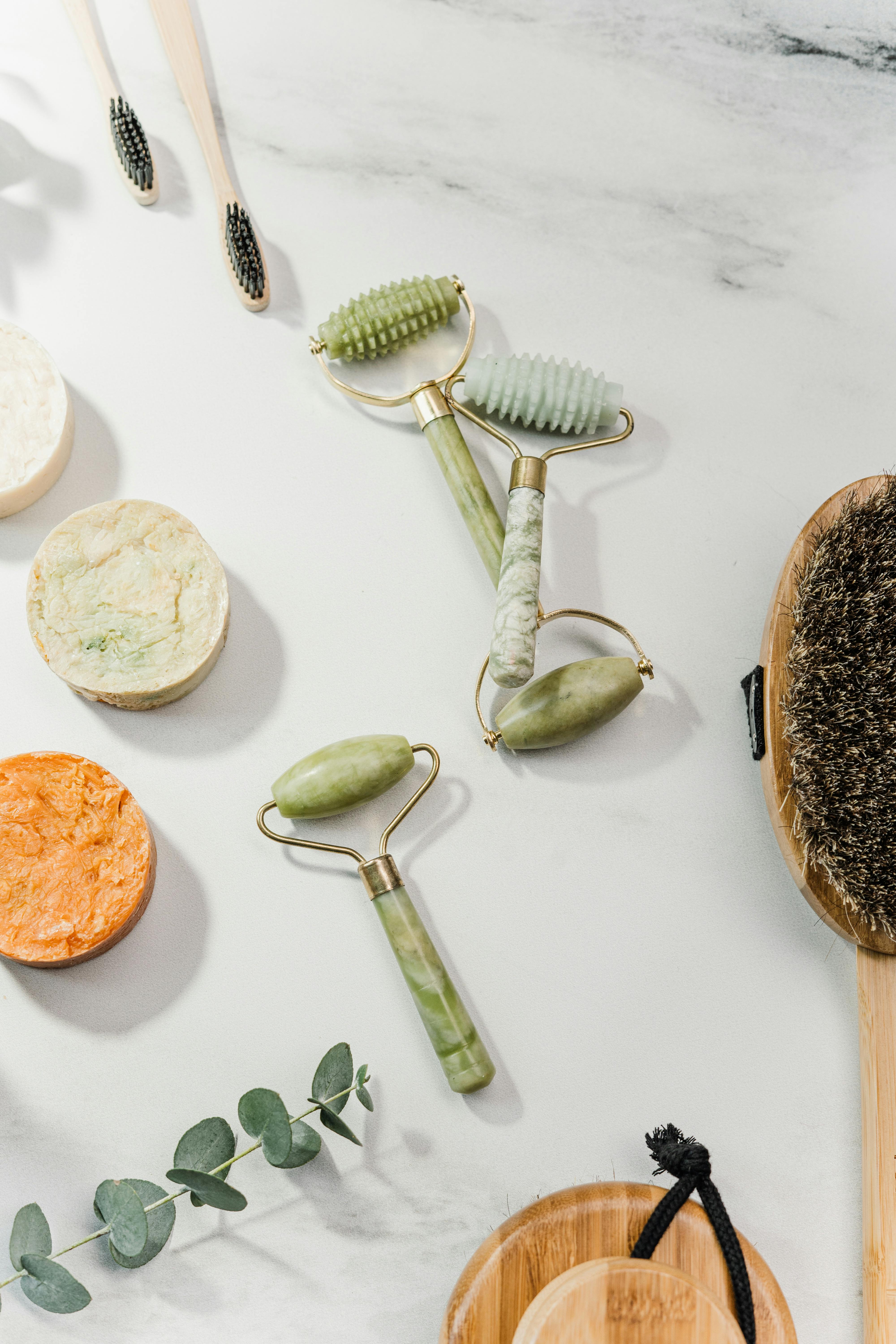 a flatlay of toiletries and facial rollers