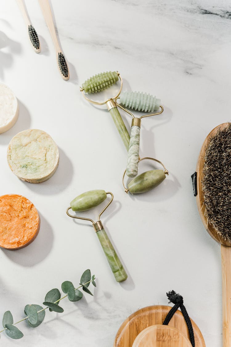 A Flatlay Of Toiletries And Facial Rollers