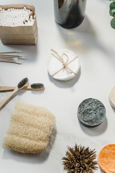 Eco-friendly toiletries including bamboo brushes and natural sponges for sustainable self-care.