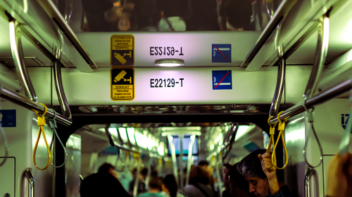 Free A crowded subway interior showing handles and no smoking signs. Stock Photo