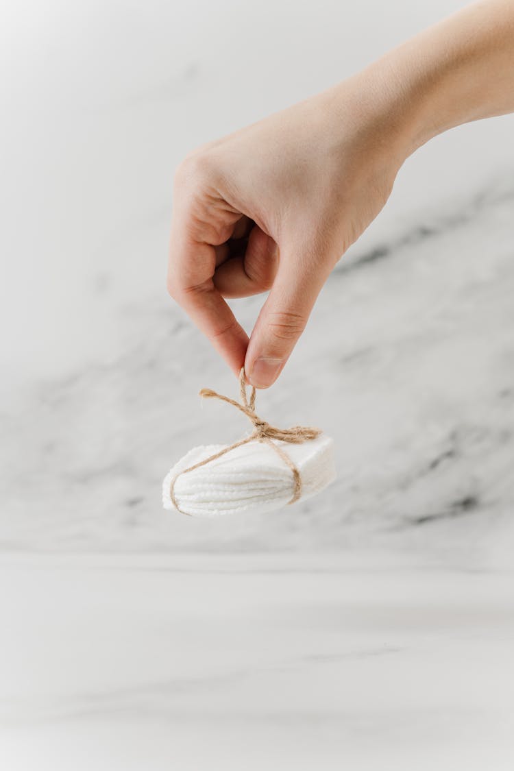 Person Holding A Bamboo Makeup Removal Pads