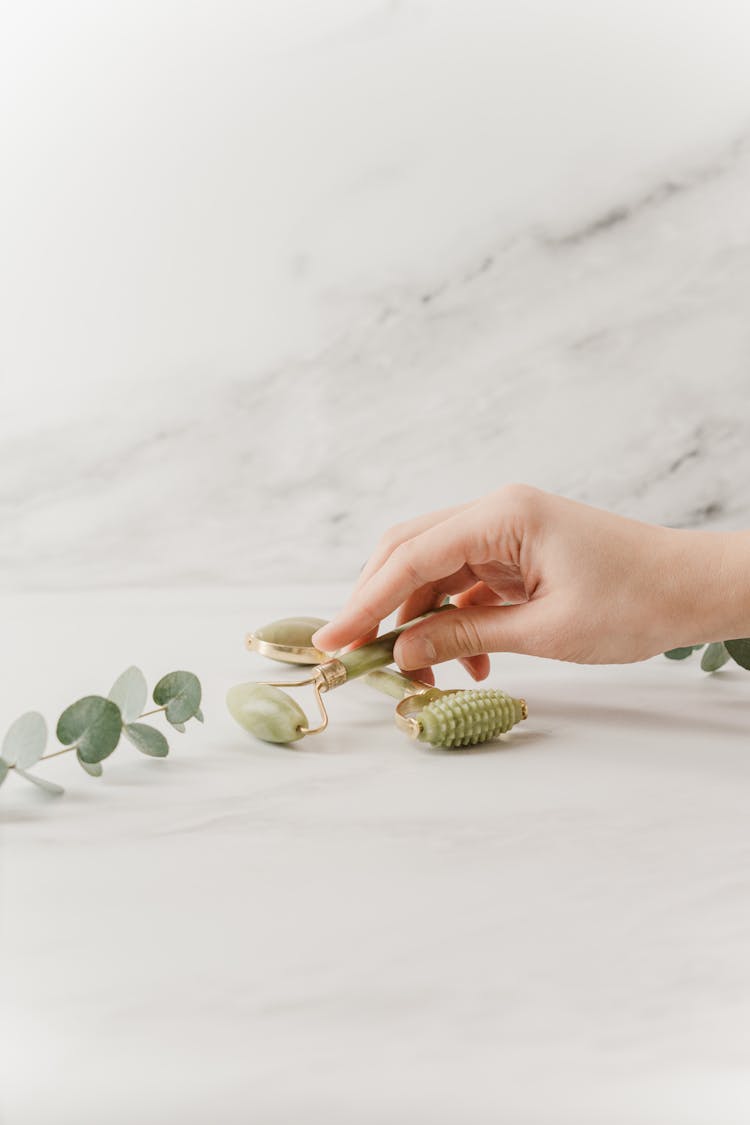 Person Holding Jade Face Roller