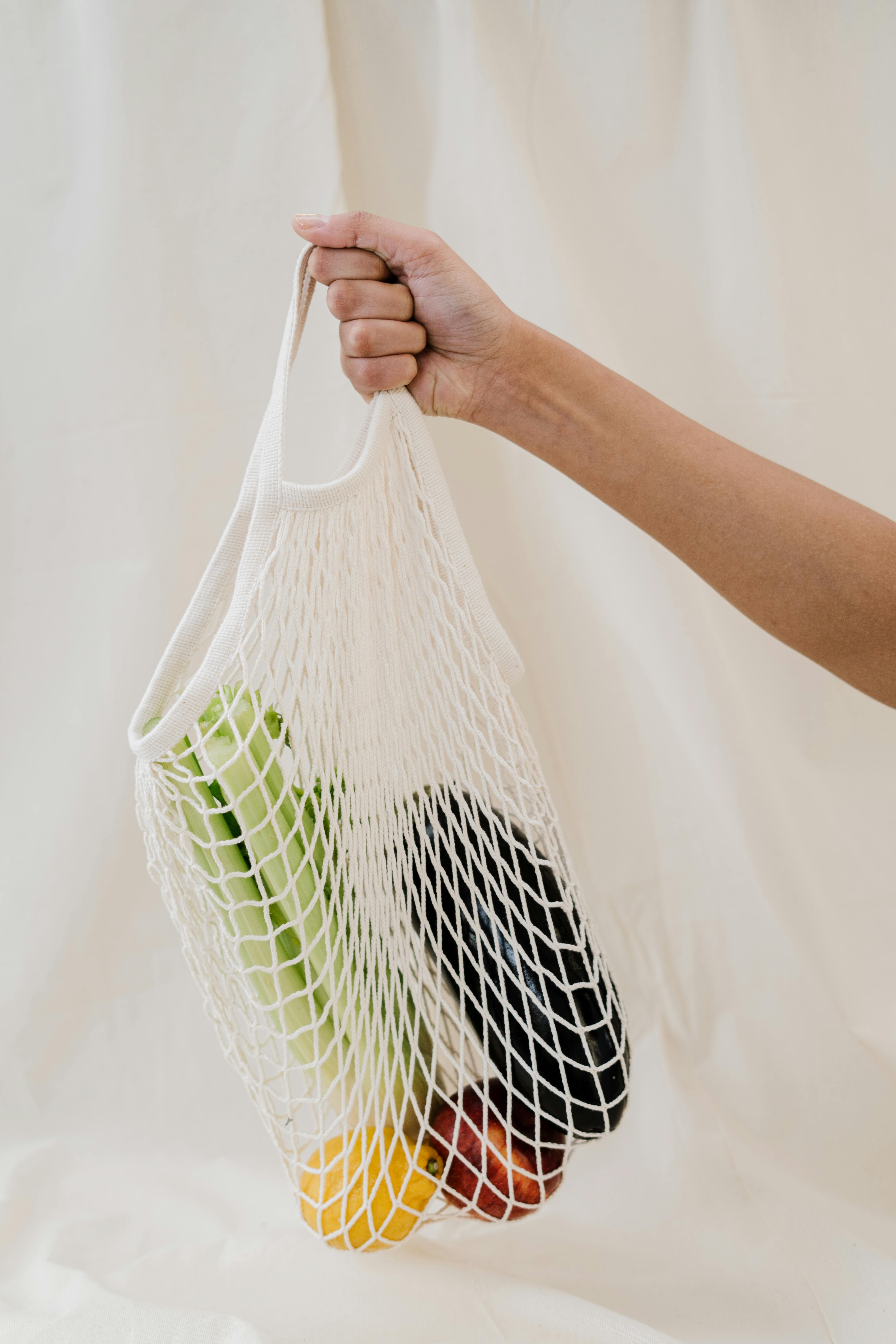 person holding a net bag