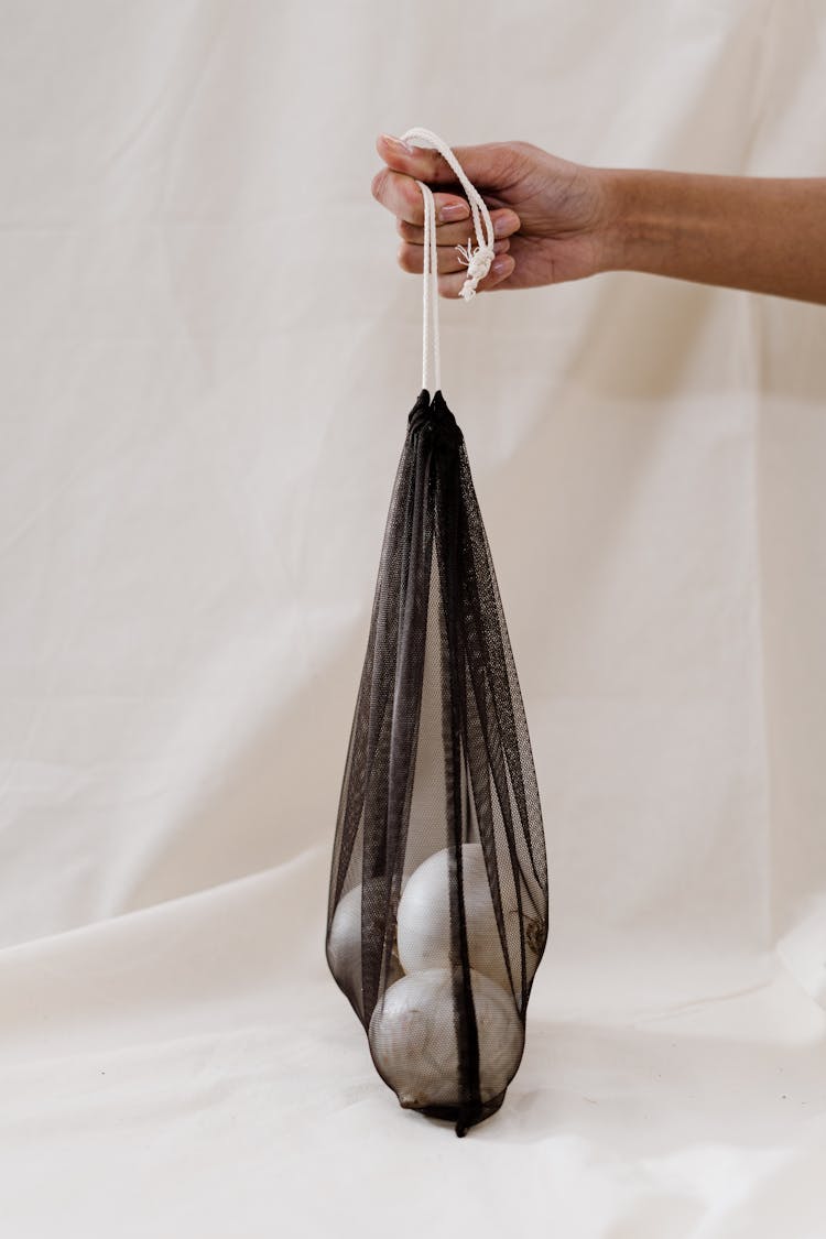 Person Holding Black Cloth Bag With Onions