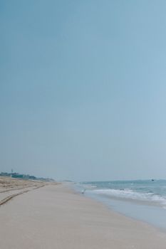 A tranquil beach scene with gentle waves and a clear blue sky, perfect for relaxation.