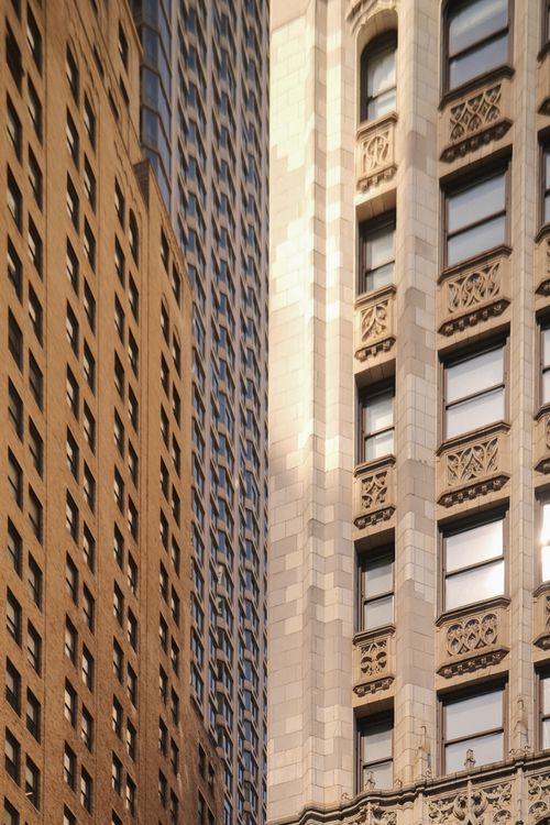 Free Detailed view of ornate skyscraper facades in New York City, highlighting architectural contrast and urban design. Stock Photo