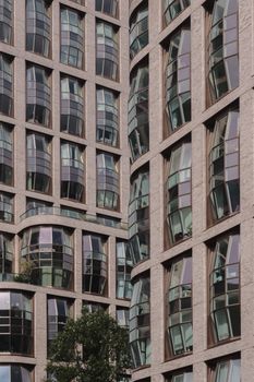 Detail of a contemporary building facade with unique curved glass windows showing architectural innovation.