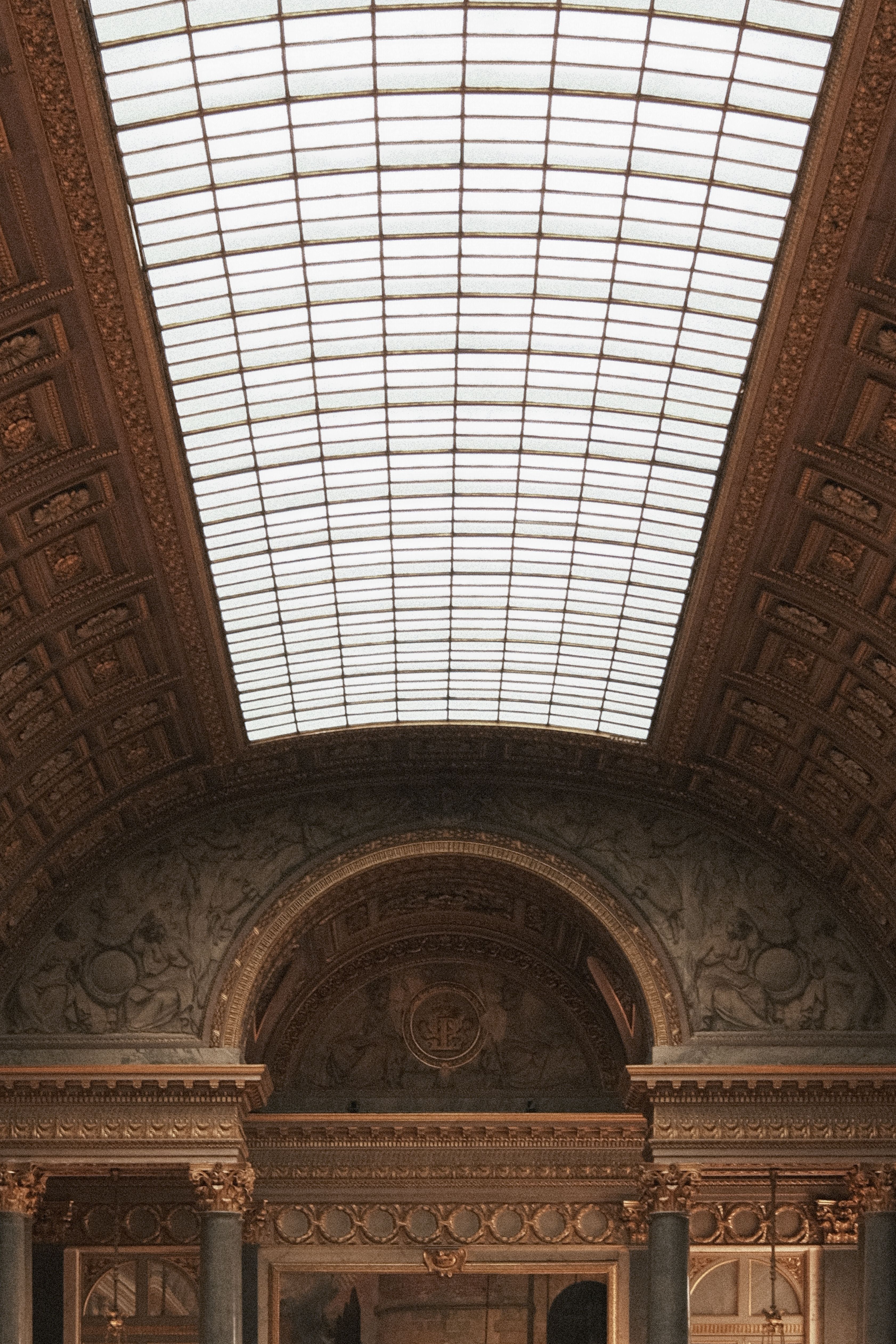 Capture of an ornate arched ceiling in a historical building, showcasing intricate architectural details.