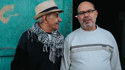Free Two senior adults in casual attire smiling and interacting outdoors. Stock Photo