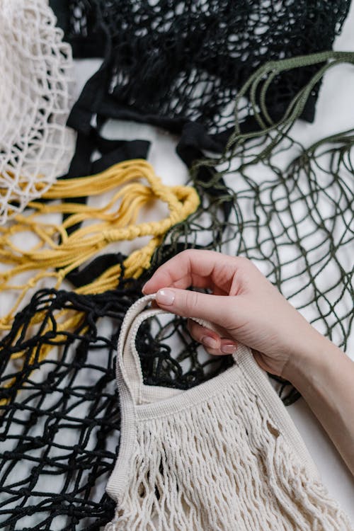 Person Holding White Mesh Bag