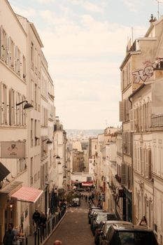 Picturesque view of Montmartre streets, Paris, showcasing classic architecture and vibrant street life.