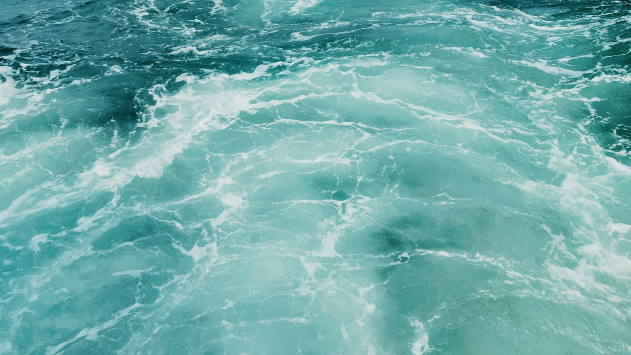 a captivating view of the turquoise and teal waves on the ocean surfac